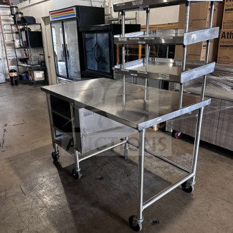 Stainless steel commercial work table with multi-tier overshelf, approx. 60"x36", mobile, inspected, ready for use.