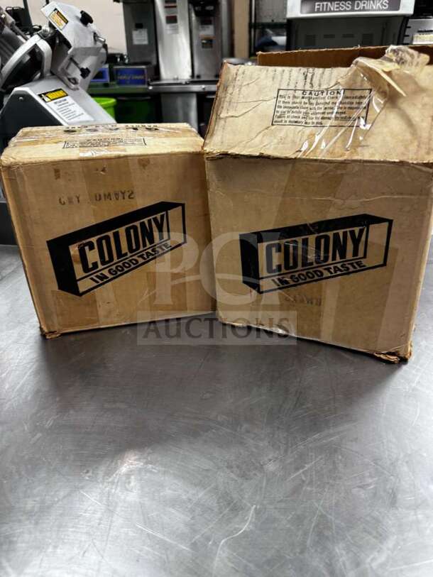 Two boxes labeled "Colony" containing Crisp Crystal Apple-Shaped Glass Salad Plates, 16 plates total, new open box.