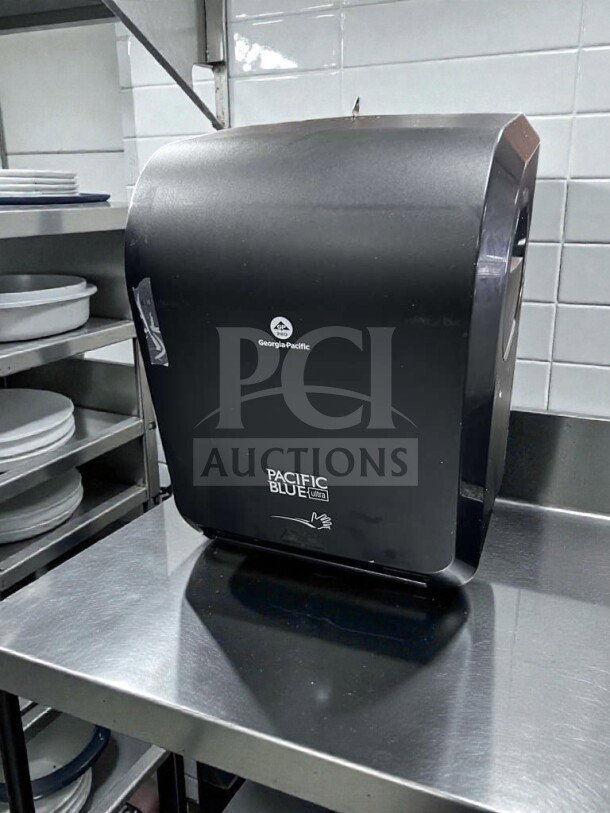 Black GP PRO Pacific Blue Ultra 59590 touchless paper towel dispenser in like-new condition, shown on a stainless steel counter.