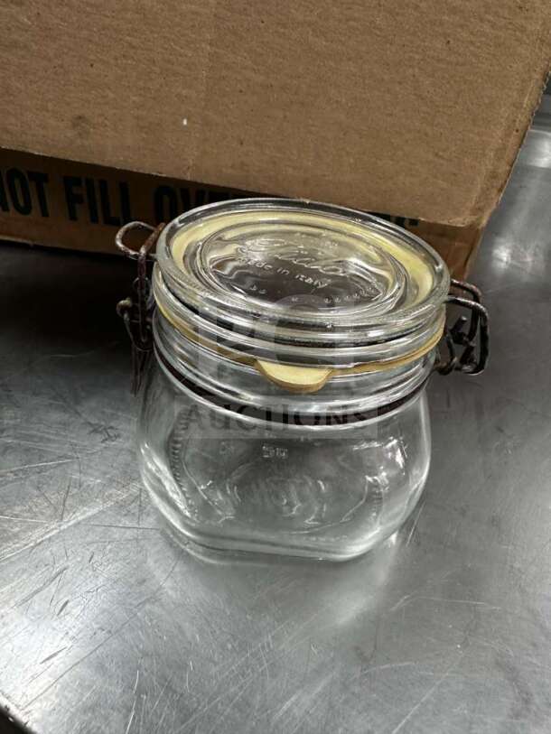Bormioli Rocco Fido 1/2L glass jar with airtight clamp lid, pristine condition, embossed "Made in Italy," ready for use.