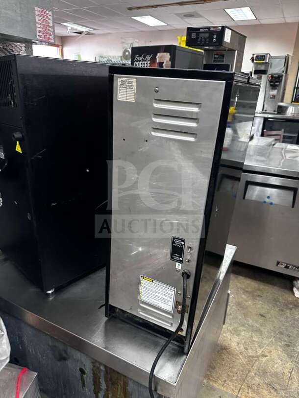 Wilbur Curtis PC-3D-10-01 cappuccino dispenser, 3 flavor stations, stainless steel, excellent condition, labels visible.