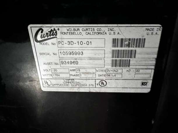 Wilbur Curtis cappuccino dispenser label, model PC-3D-10-01, serial 10595993, 120V, 1764 watts, made in USA.