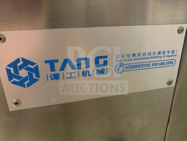TANG Two-Head Automatic Filling Machine, model TAN-L-FIL-0423, features logo and contact details on a metallic surface.