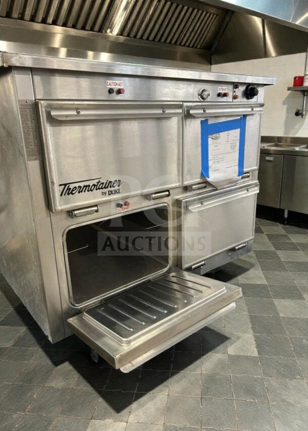 Duke Thermotainer Heated Holding Cabinet, excellent condition, 208V/3 Phase, fully tested, stainless steel with "Caution Hot" labels.