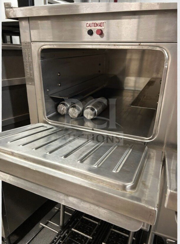 Duke Thermotainer Heated Holding Cabinet, excellent condition, 208V/3 Phase. Interior view shows shelves and caution hot label.