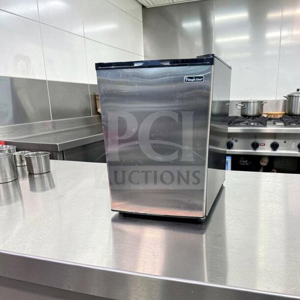 Magic Chef MCUF3S2 compact upright refrigerator in stainless steel, excellent condition, space-saving design, fully tested operational.