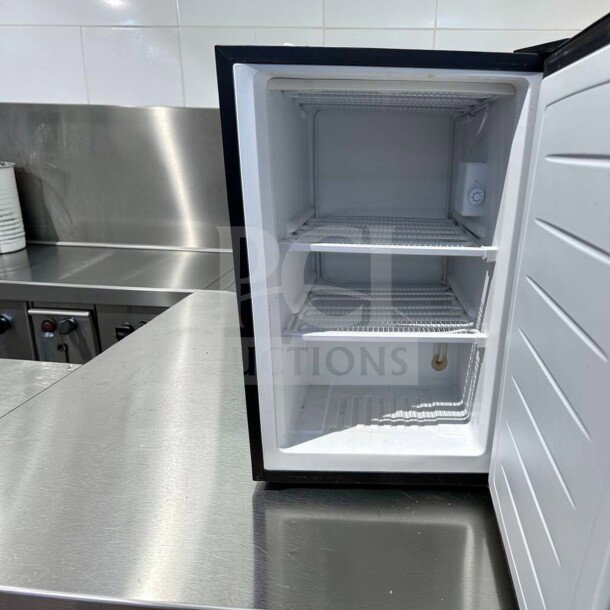 Magic Chef MCUF3S2 3 Cu. Ft. compact refrigerator in stainless steel. Excellent condition, includes shelving, space-saving design.
