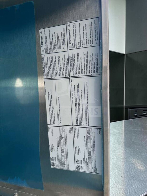 Commercial stainless steel vent hood, exceptional condition, heavy-duty kitchen ventilation canopy, NSF/ETL certified. Visible safety labels included.