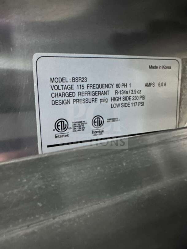 Blue Air BSR23-HC Refrigerator label showing model BSR23, voltage 115, refrigerant R-134a. Commercial grade stainless steel.