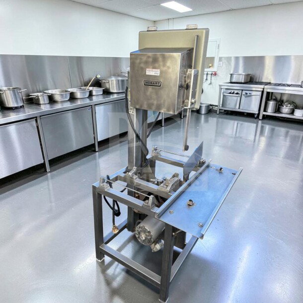 Hobart 5701D commercial meat saw, 3 HP, 3-phase, stainless steel, excellent condition, fully tested, industrial kitchen setting.