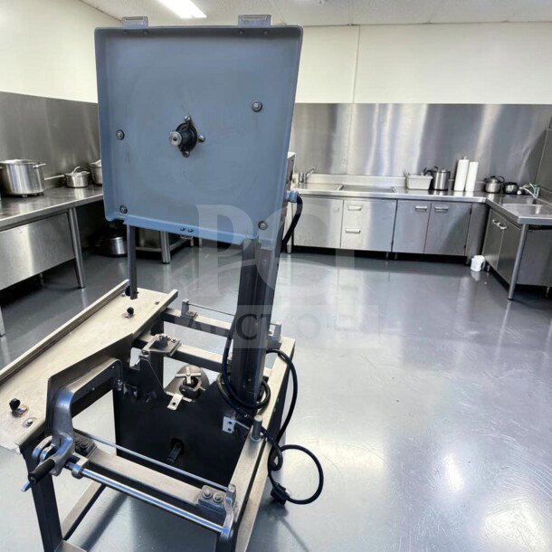 Hobart 5701D commercial meat saw in superior condition, 3 HP, 3 phase, fully operational in a stainless steel kitchen setting.