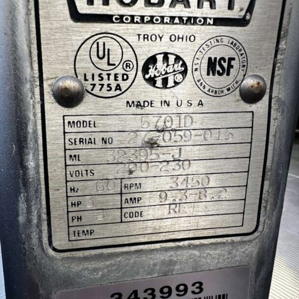 Label on Hobart 5701D meat saw showing model, serial number, voltage, horsepower, and compliance logos.