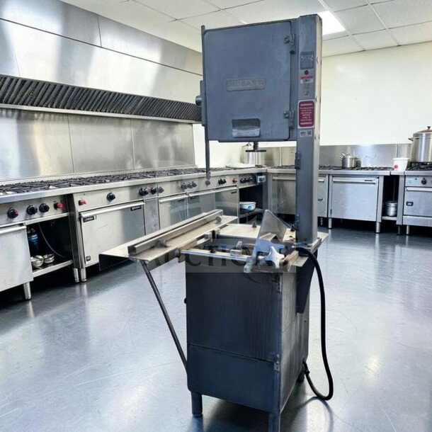 Hobart 5614 commercial meat saw, 2 HP, 3 phase, for parts or repair, visible wear, in a professional kitchen setting.