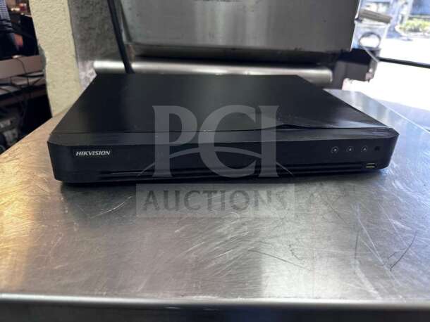 Hikvision DS-7216HQI-K2 16-Channel DVR, elite condition, fully tested, operational, sleek black design, USB port visible.