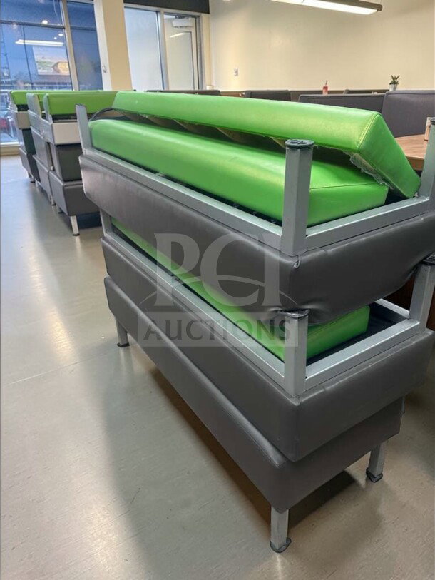 Commercial restaurant booth seating with green upholstered vinyl cushions, heavy-duty frame, superb condition.
