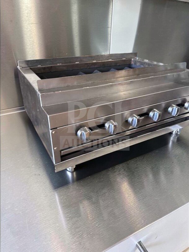 IDEAL 48" gas charbroiler with 6 burners, stainless steel, excellent condition, fully operational, commercial-grade.