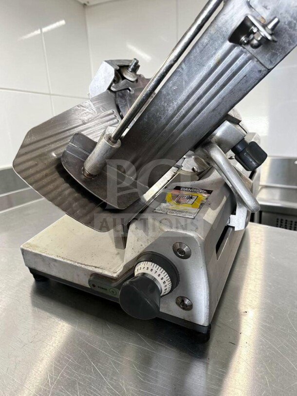 German Knife GS-12M 12" manual slicer, 1/2 HP, gravity feed, in excellent condition, fully tested operational.