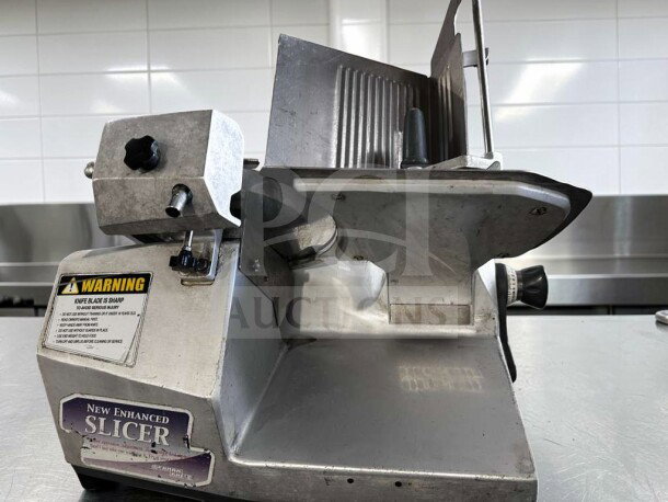 German Knife GS-12M slicer, 12" blade, heavy duty, excellent condition, gravity feed, 1/2 HP, tested, with warning labels.