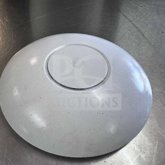 Ubiquiti UniFi UAP-AC-PRO wireless access point, dual band, 1750 Mbps, superior condition, on metallic surface.