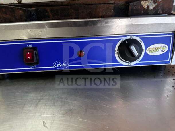 Globe GSG1410 panini grill with smooth iron plates, 14"x10" surface. Features on/off switch, temperature dial, and blue casing.