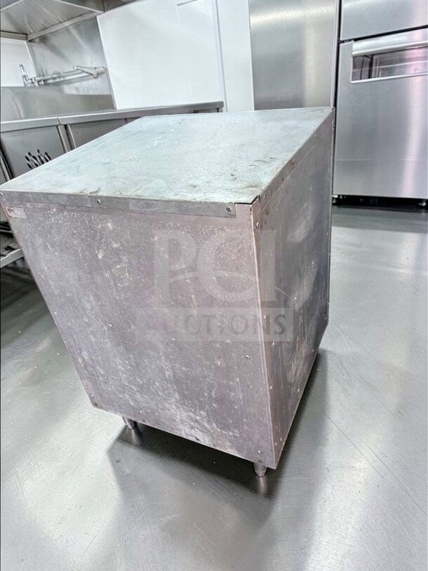 Commercial stainless steel equipment stand in excellent condition; heavy-duty with open shelf storage, ideal for kitchen use.