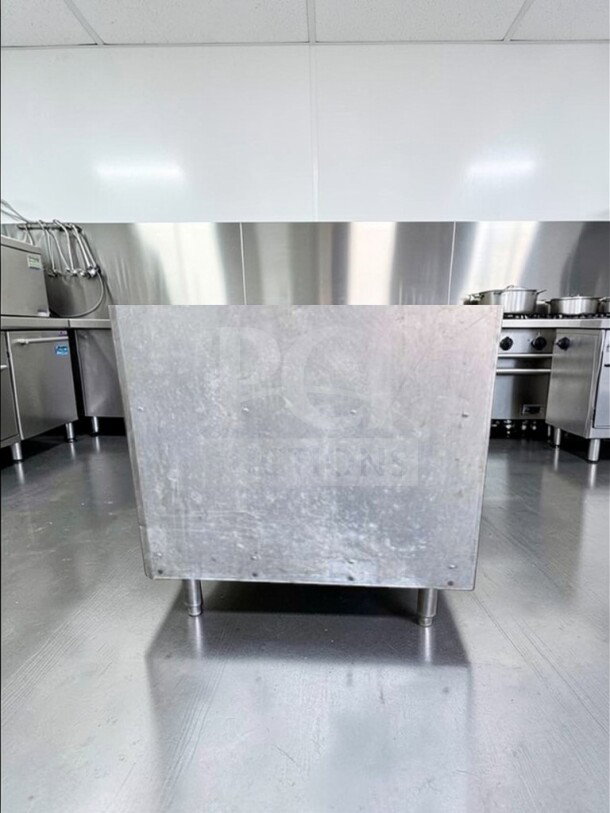 Stainless steel equipment stand, excellent condition, with open shelf. Model COM-S-STD-0687. Ideal for commercial kitchens.