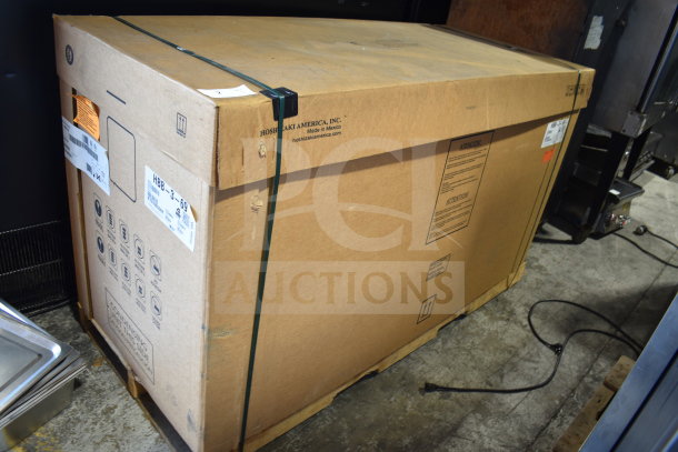 Brand new Hoshizaki HBB-3-69 back bar cooler, in packaging. Some scratches, dent visible. Model and specs on box.