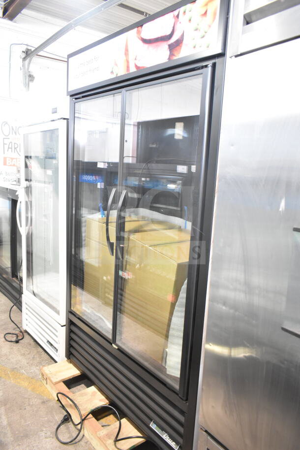 Brand new True TVM-48SL-HC merchandiser cooler, 2 glass doors, 115V, minor scratches, freestanding commercial appliance.