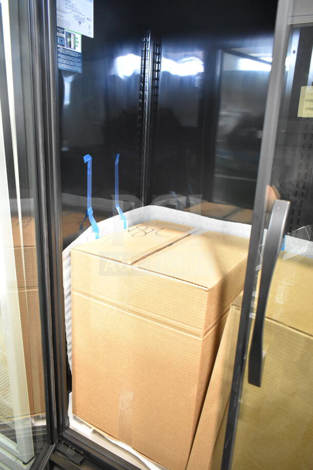 Brand new True TVM-48SL-HC commercial cooler, 2-door, 115V, 1 phase. Scratch and dent condition, packaging visible inside.