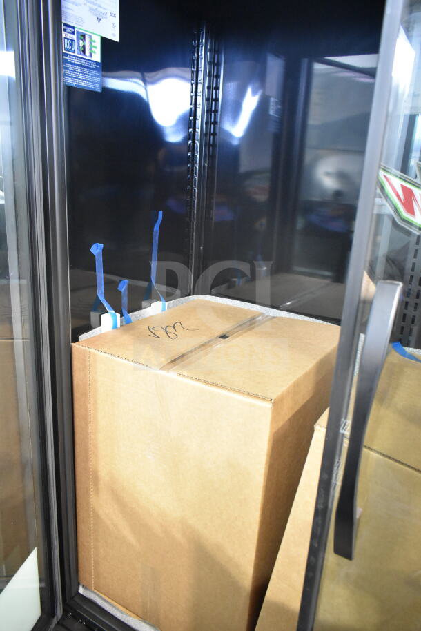 "Brand new 2026 True TVM-48SL-HC 2-door cooler, scratch and dent condition, 115V, 1 Phase, interior view with packaging."