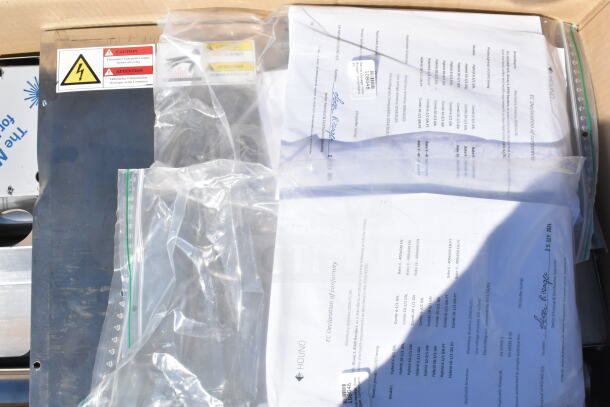 Brand new Blodgett Invoq Hybrid 6-1/1 GN combi convection oven with user manuals. Caution label on the unit.