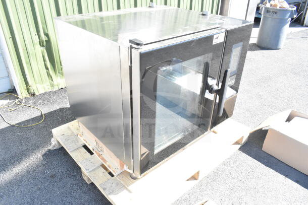 Brand new 2023 Blodgett Invoq Hybrid 6-1/1 GN electric combi oven on pallet, stainless steel, visible minor dents.
