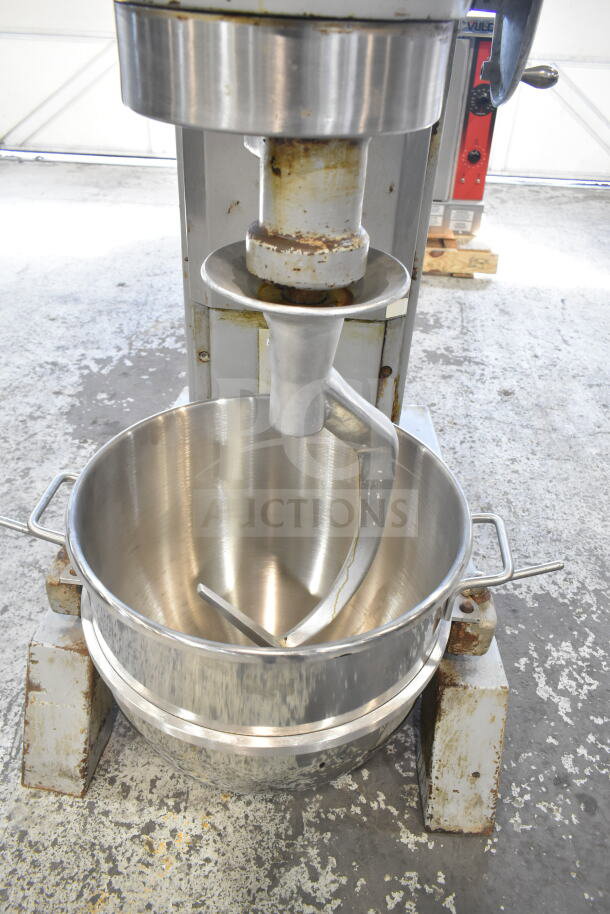 Hobart P 660 60-quart commercial dough mixer with mixing bowl and dough hook. Features 208-240V, 3-phase power, showing some wear.