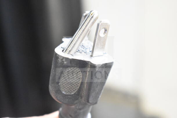 Close-up of a power plug for the True GDM-41SL-60-LD commercial cooler, showing a standard 115V connection.