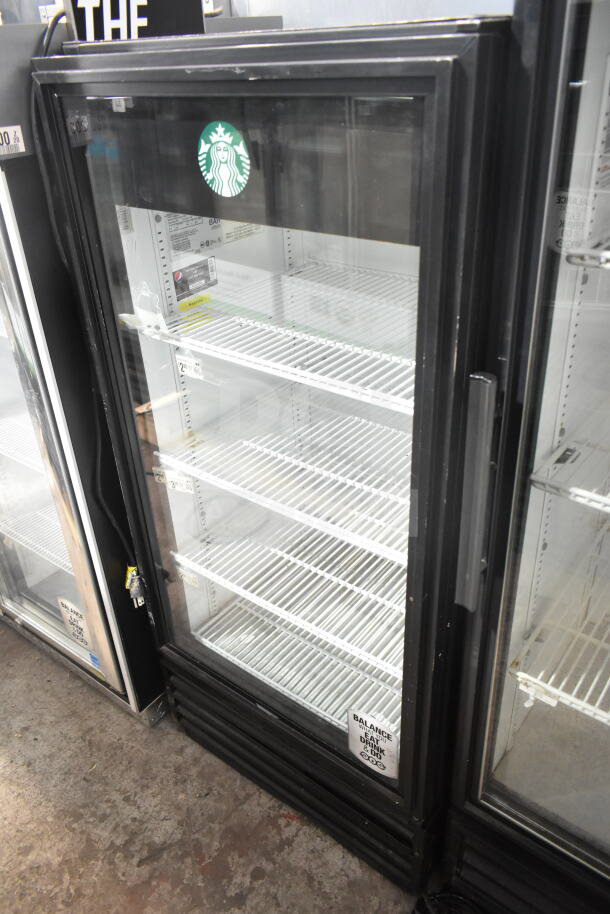True GDM-10 commercial single door cooler merchandiser, 115 volts, features glass door, white interior shelving, model label visible.