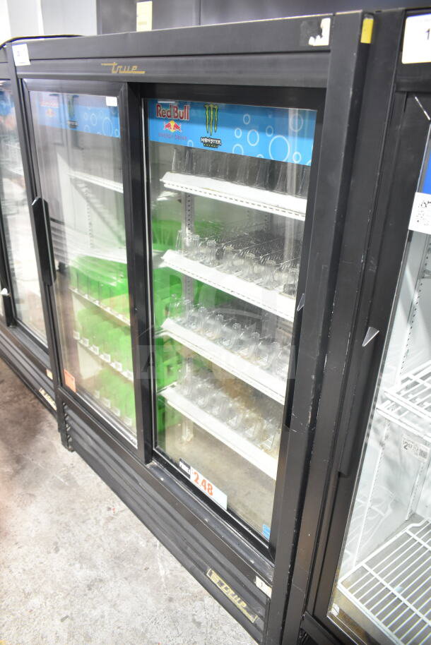 True GDM-41SL-60-LD Commercial 2 Door Reach In Cooler Merchandiser, 115 Volts, features glass doors and shelving for display.