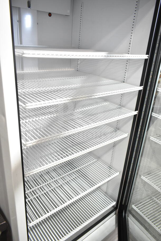 2021 True TSCI-600R-G-PH commercial single-door reach-in cooler merchandiser, white interior, multiple shelves, 115V, 1 phase.