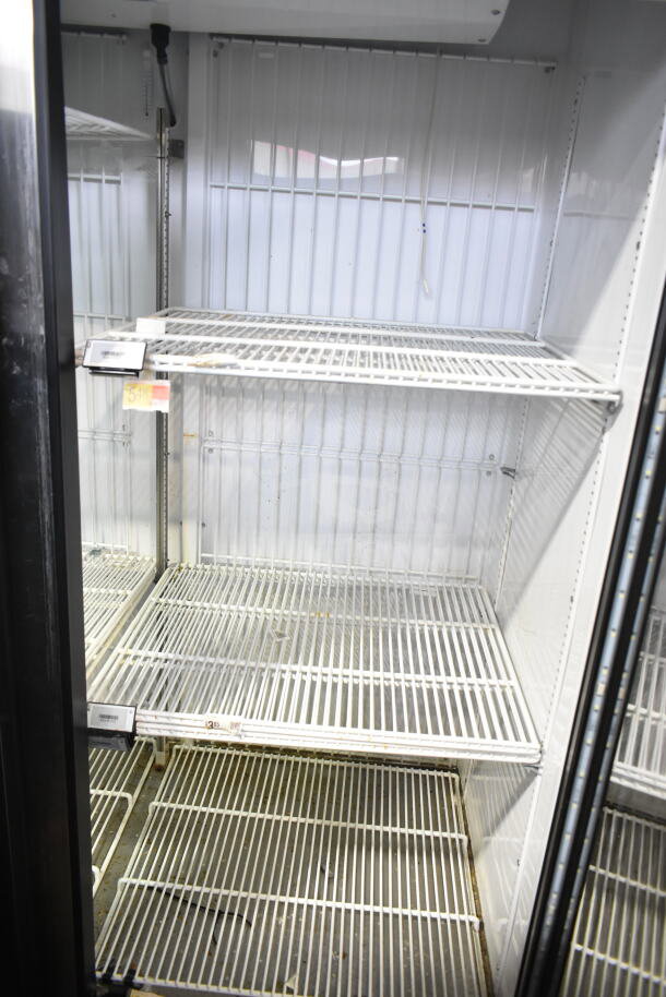 2021 True GDM-49F-HC cooler, commercial 2-door, 115 volts, 1 phase, empty interior with shelves shown.