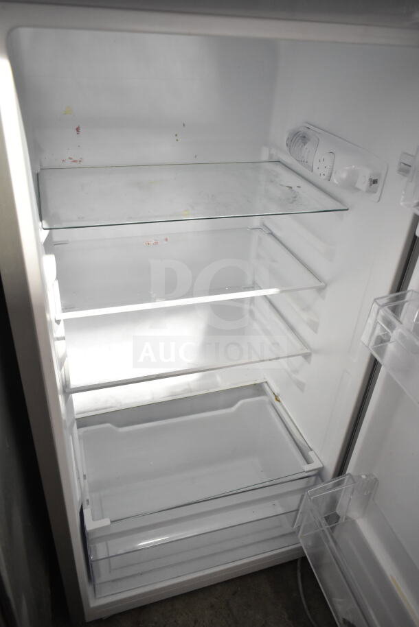 Frigidaire EFR780-T-6COM reach-in cooler with freezer, 115 volts, 1 phase. Features multiple glass shelves. Some surface wear visible.