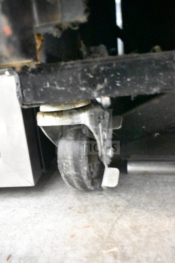 2017 True T-35 Commercial 2 Door Cooler caster wheel close-up. Model T-35, 115 Volts, 1 Phase, showing some wear.