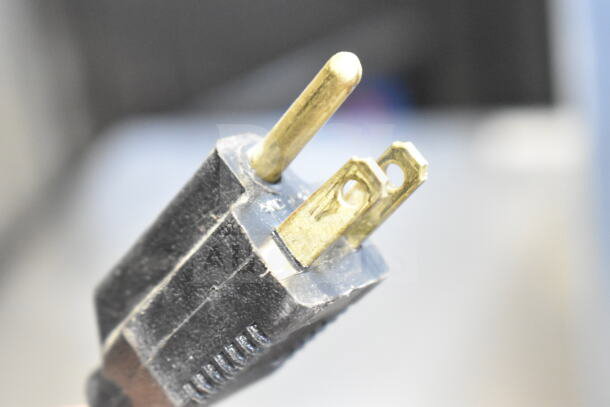 Close-up of a power plug from a True GDM-06-LD mini cooler merchandiser; 115 volts, 1 phase, three-prong design.