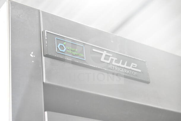 2017 True T-35-HC 2-door reach-in cooler, on commercial casters, visible "natural refrigerant" label.