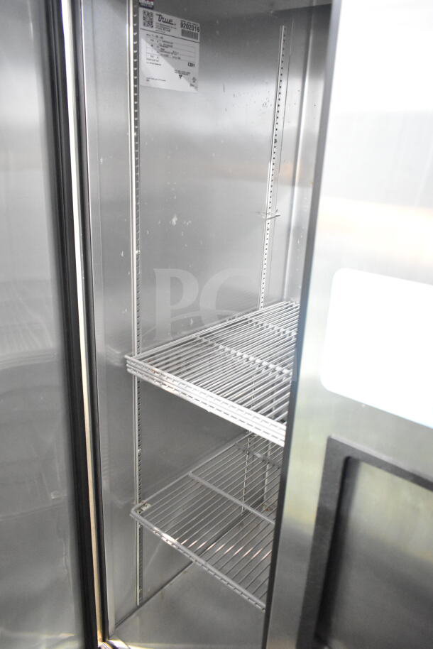 2017 True T-35-HC 2 Door Reach-In Cooler, commercial casters, 115V, 1 phase. Interior shelves shown, label visible.