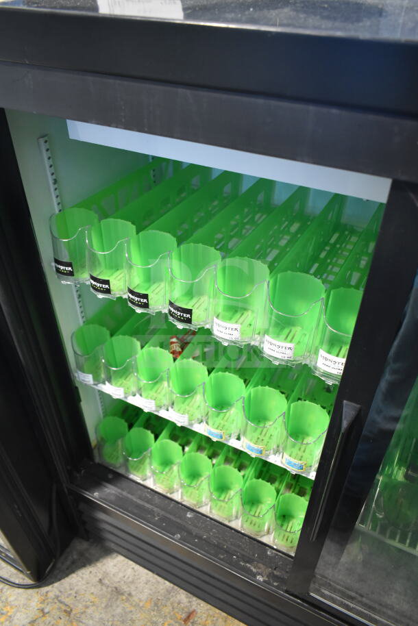 2019 True GDM-41SL-48-HC-LD commercial cooler with two glass doors, green interior racks, suitable for merchandising.