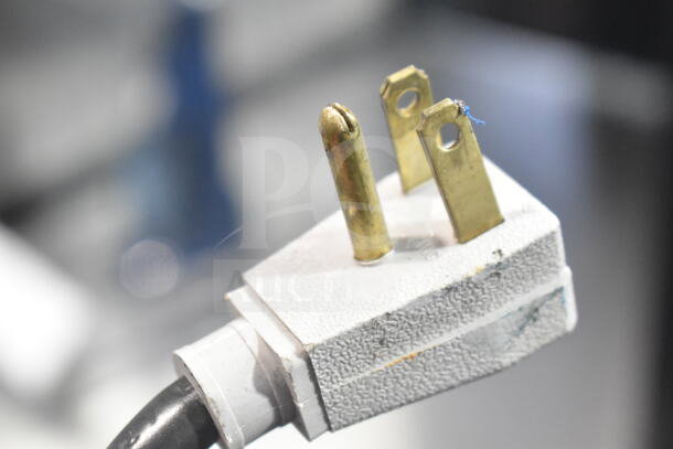 Close-up of a three-prong plug from a 2019 True GDM-41SL-48-HC-LD commercial cooler, 115 volts, 1 phase.