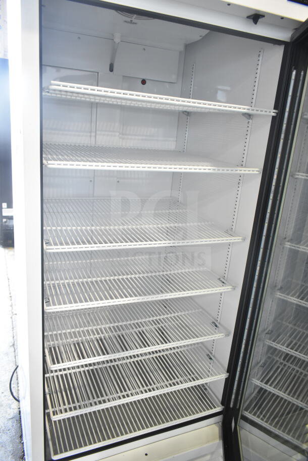 2021 True TSCI-600R-G-PH reach-in cooler merchandiser, single glass door, multiple wire shelves, 115V, excellent condition.