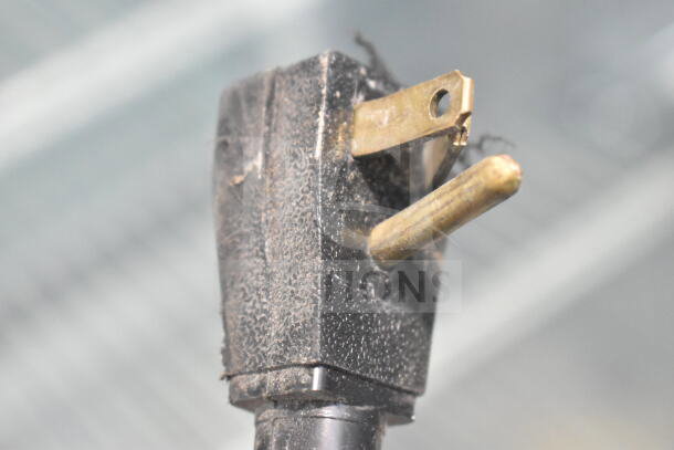 Close-up of a power plug for True TSCI-600R-G-PH Commercial Cooler, showing slight wear. 115 volts, 1 phase.