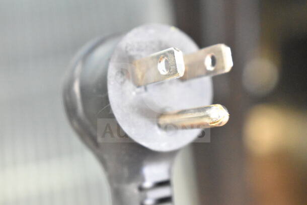 Close-up of a three-prong electrical plug, part of the 2021 True GDM-26-HC cooler merchandiser, 115 volts, 1 phase.