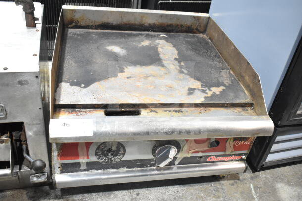 APW Wyott Champion gas-powered flat top griddle, used condition, visible wear and rust, model signage on front panel.