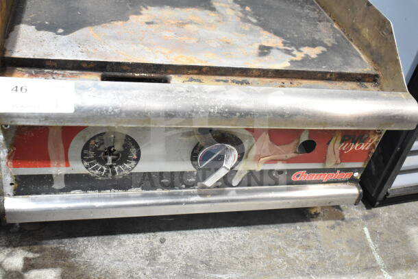 APW Wyott Champion gas-powered griddle, well-worn surface, visible rust, dial control, labeled "Champion", model tag intact.